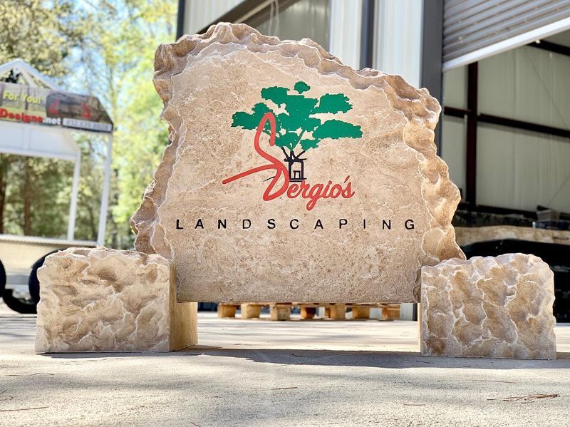 A freshly carved boulder sign staged in the fabrication yard before delivery